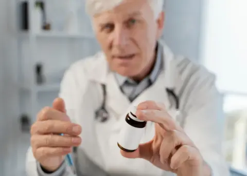 doctor giving pills 